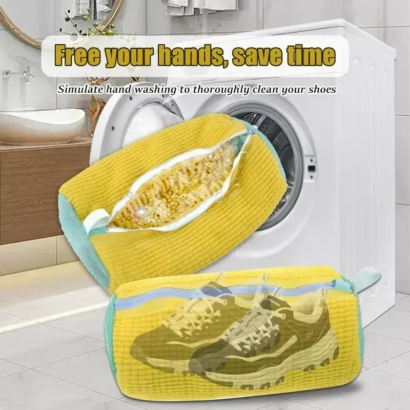 Yellow shoe cleaning device with transparent compartment showing a shoe inside, placed in front of a washing machine.